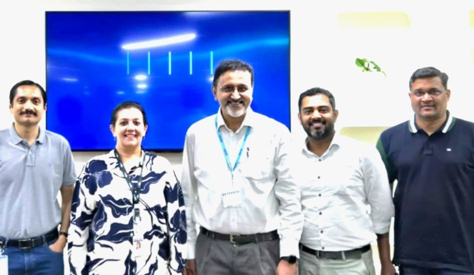 Shankar Venkatraman standing with a group of professionals in an office