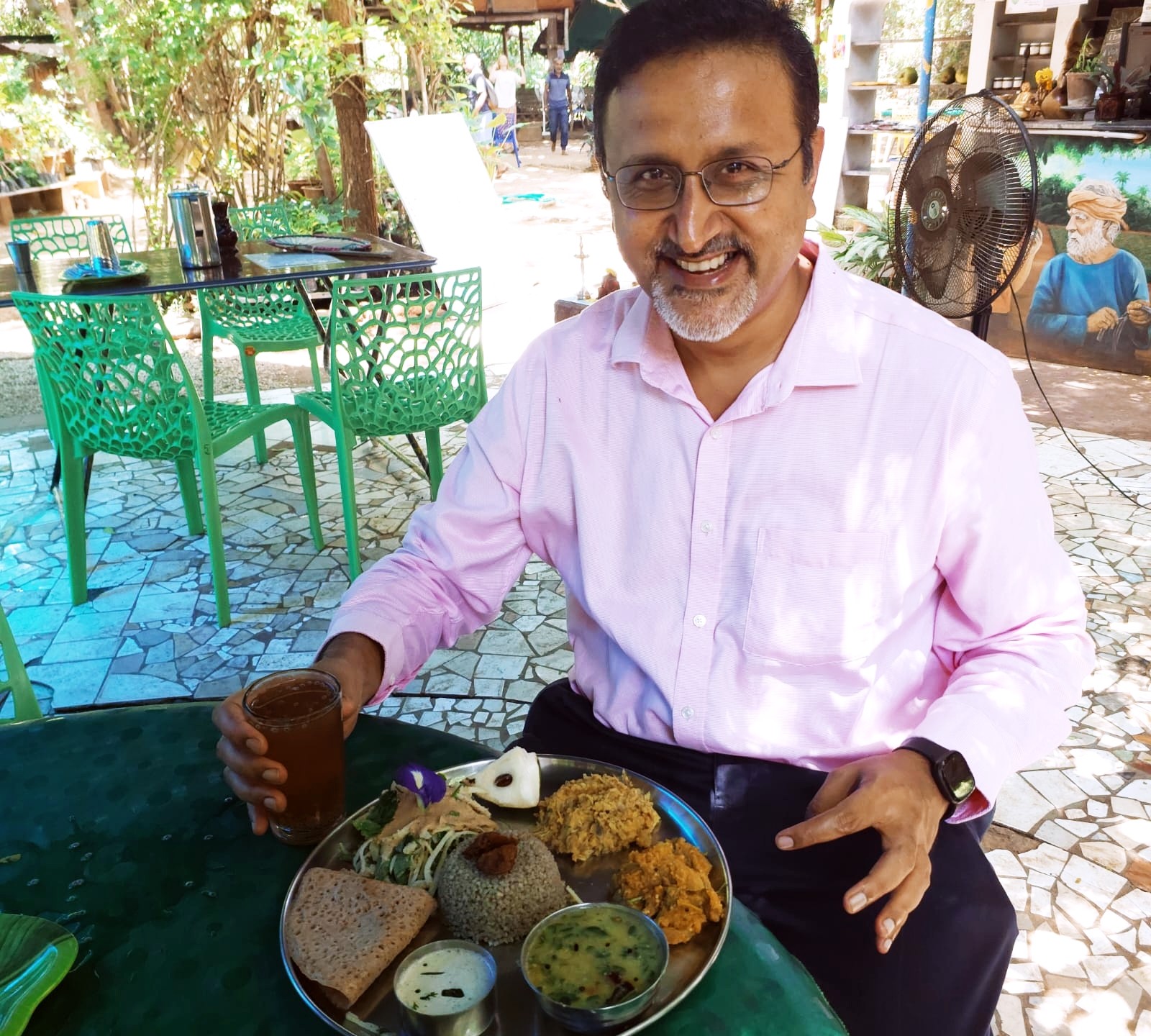 Shankar Venkatraman seated at an outdoor table with a meal